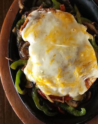 A close up of a plate of food with a fried egg on top