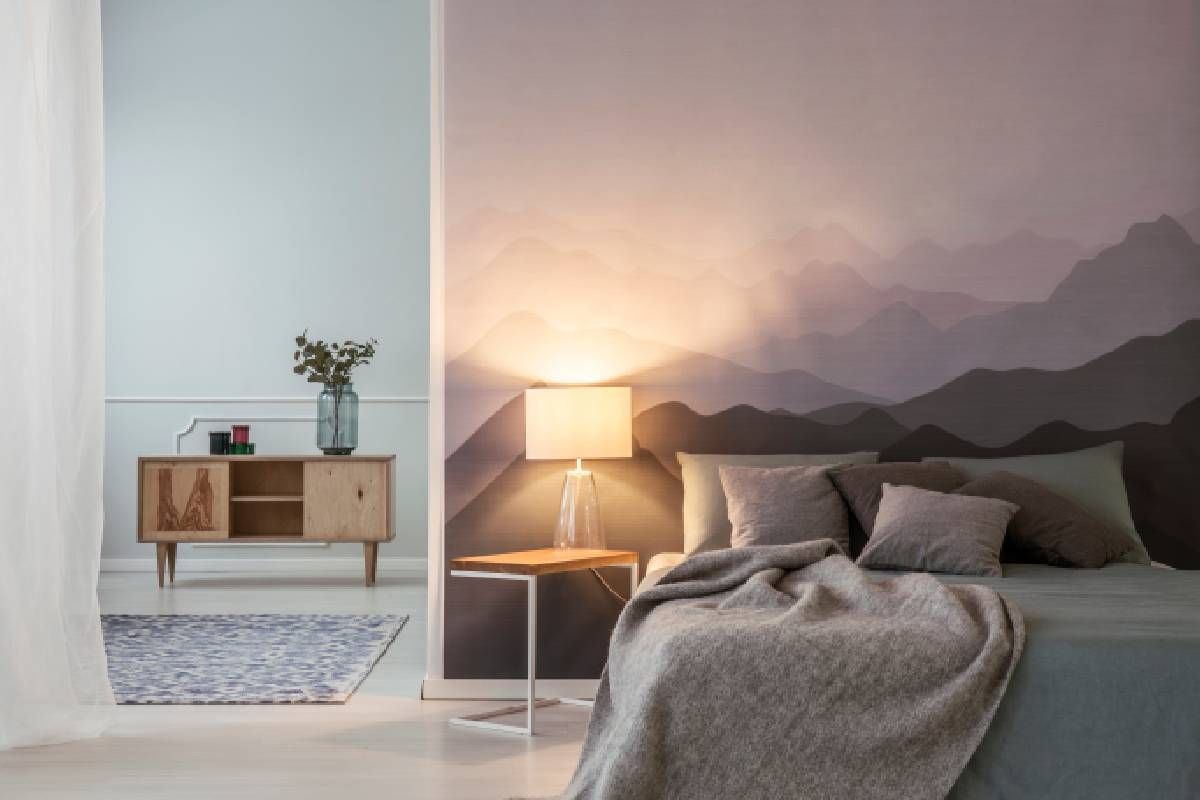 A bedroom in Lexington, KY, featuring decorative wallpaper behind a bed without a headboard