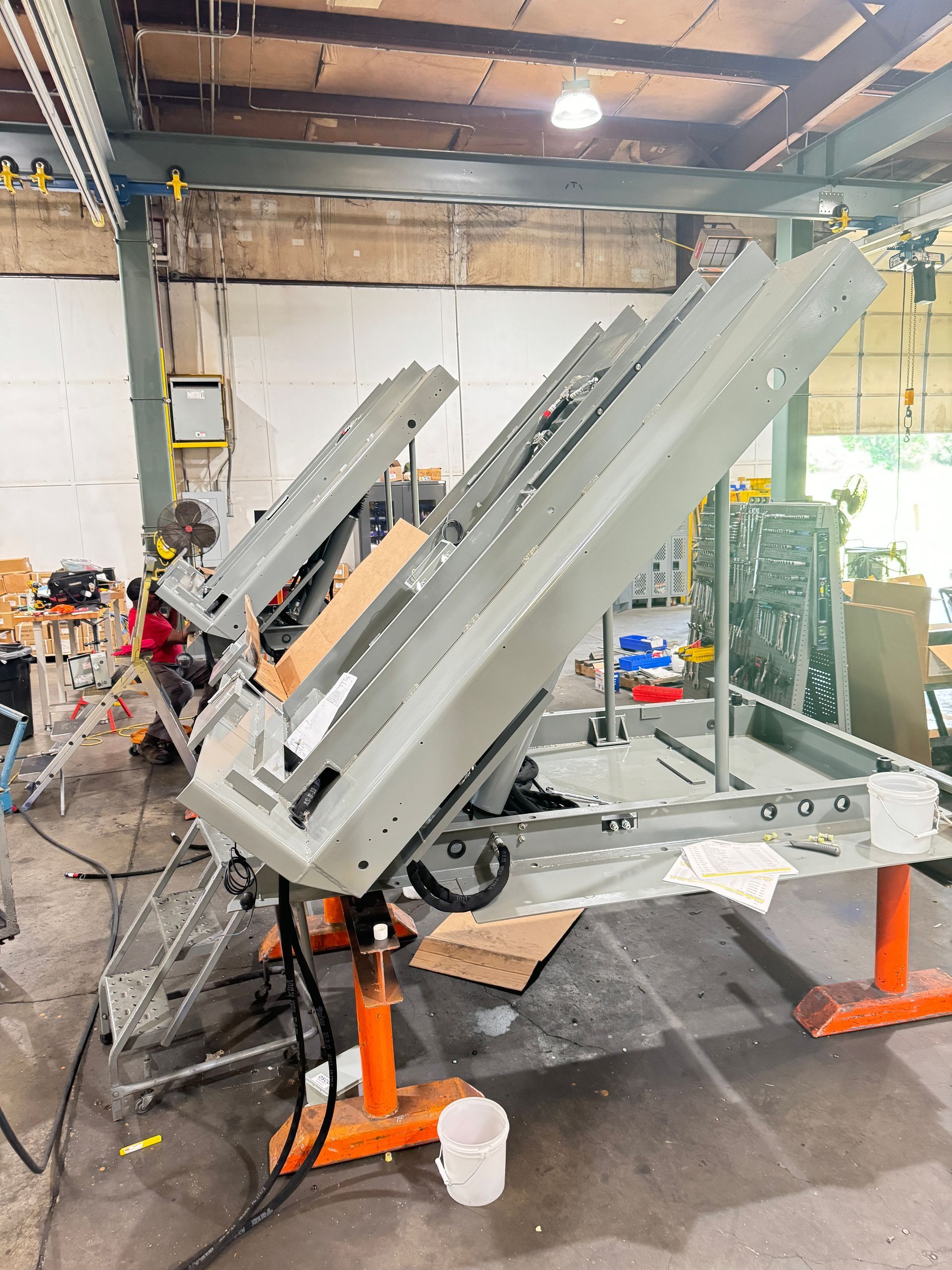 A large machine is sitting on top of a table in Autoquip's factory.