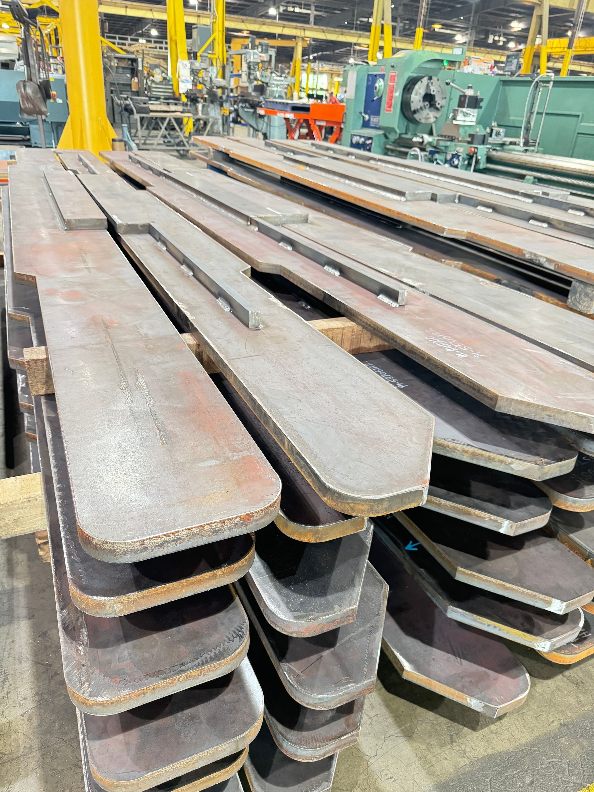 metal pieces are stacked on top of each other in Autoquip's warehouse