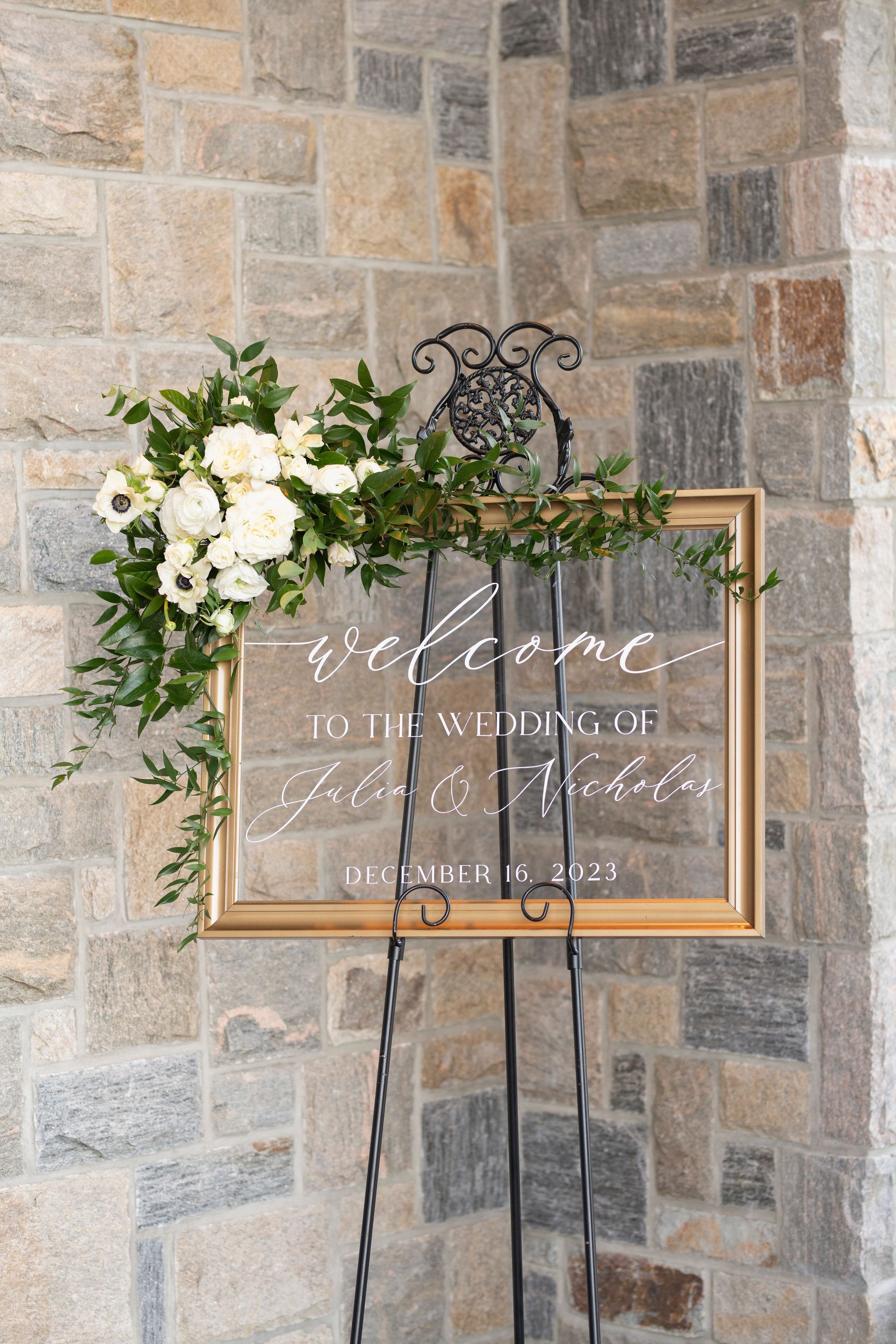 Glass wedding sign for a wedding reception with white text