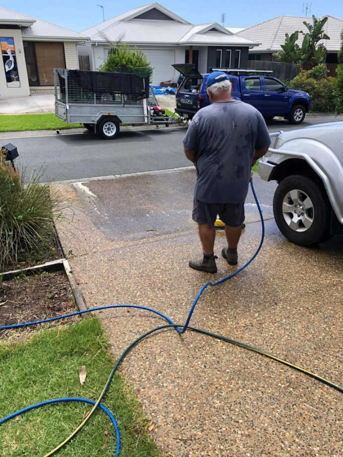 Man Cleaning The Driveway — Pressure Cleaning in Sunshine Coast, QLD