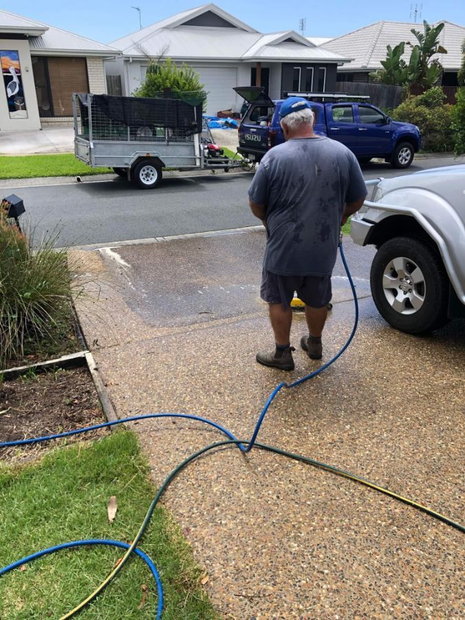 Man Cleaning The Driveway — Cleaners in Sunshine Coast, QLD