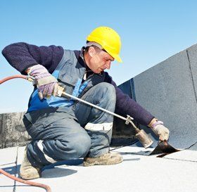 Man cleaning a flat roof