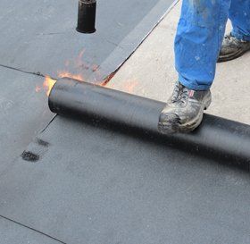 Man cleaning a flat roof