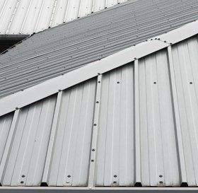 Steel roof cladding