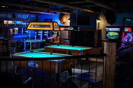 A group of people are dancing at a party in a bar.