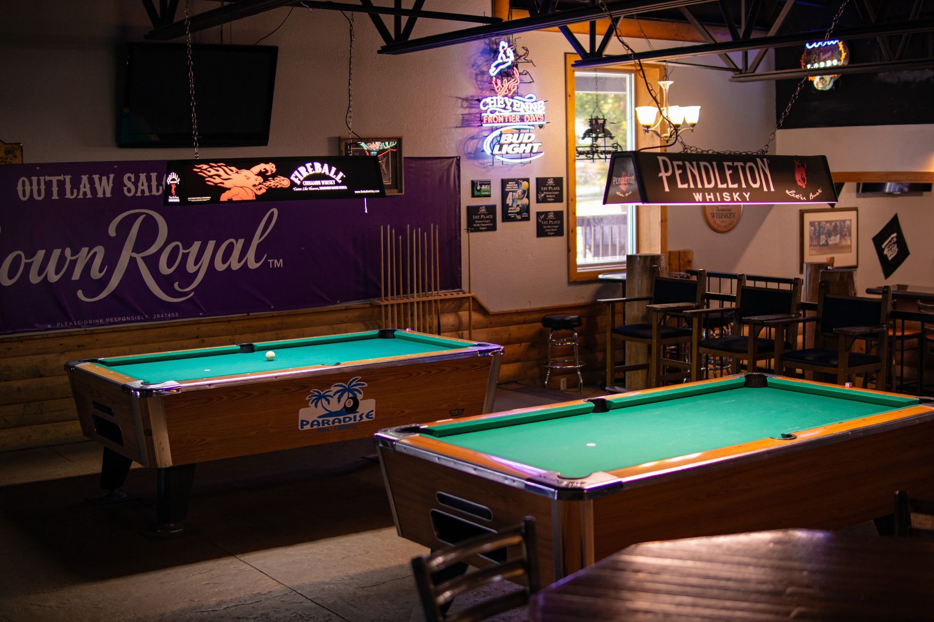 A pool table with balls and a cue on it.