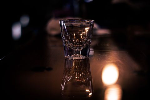 A person is pouring beer into a glass at a bar.