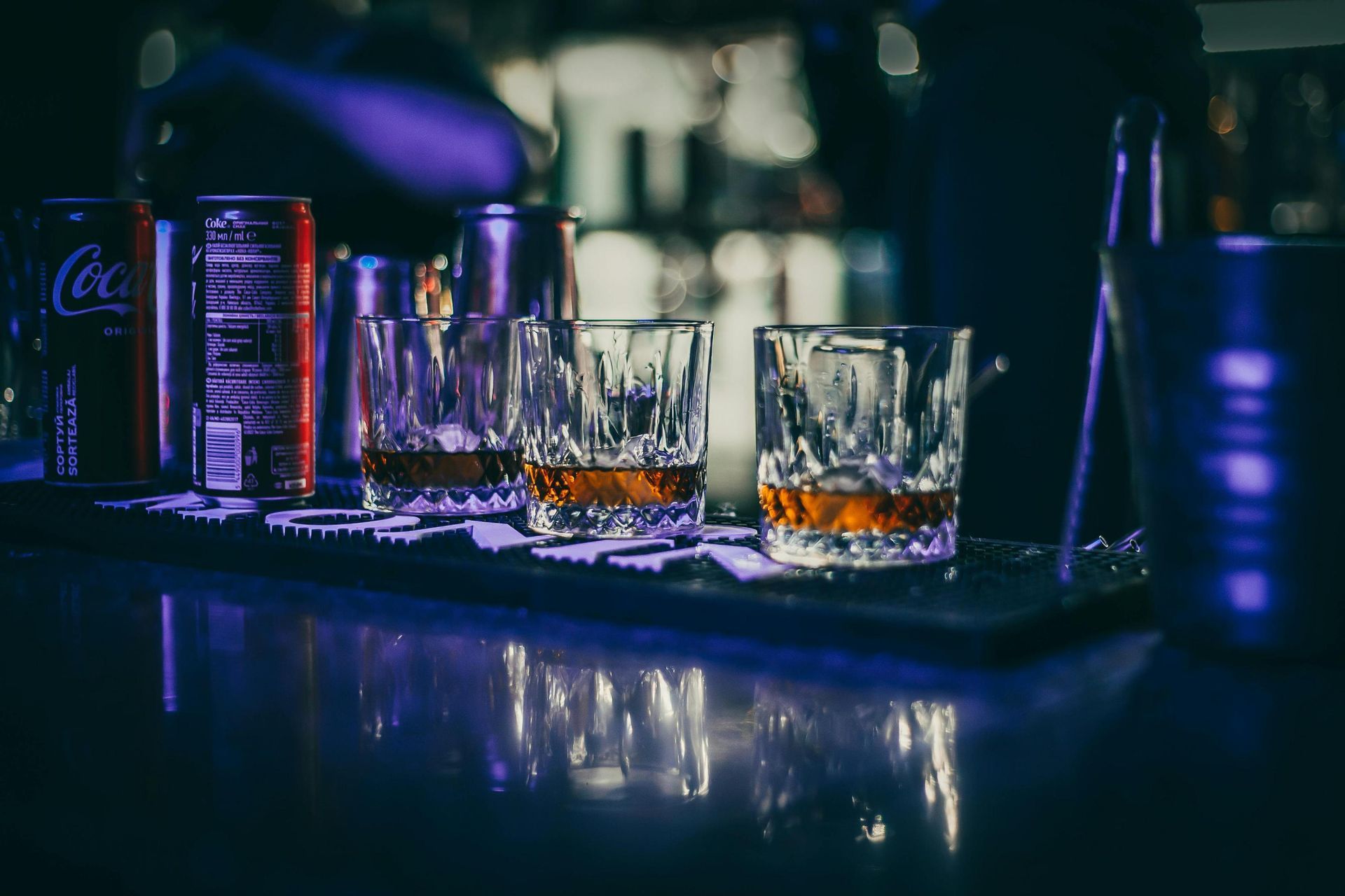 A group of people are toasting with beer in a bar.