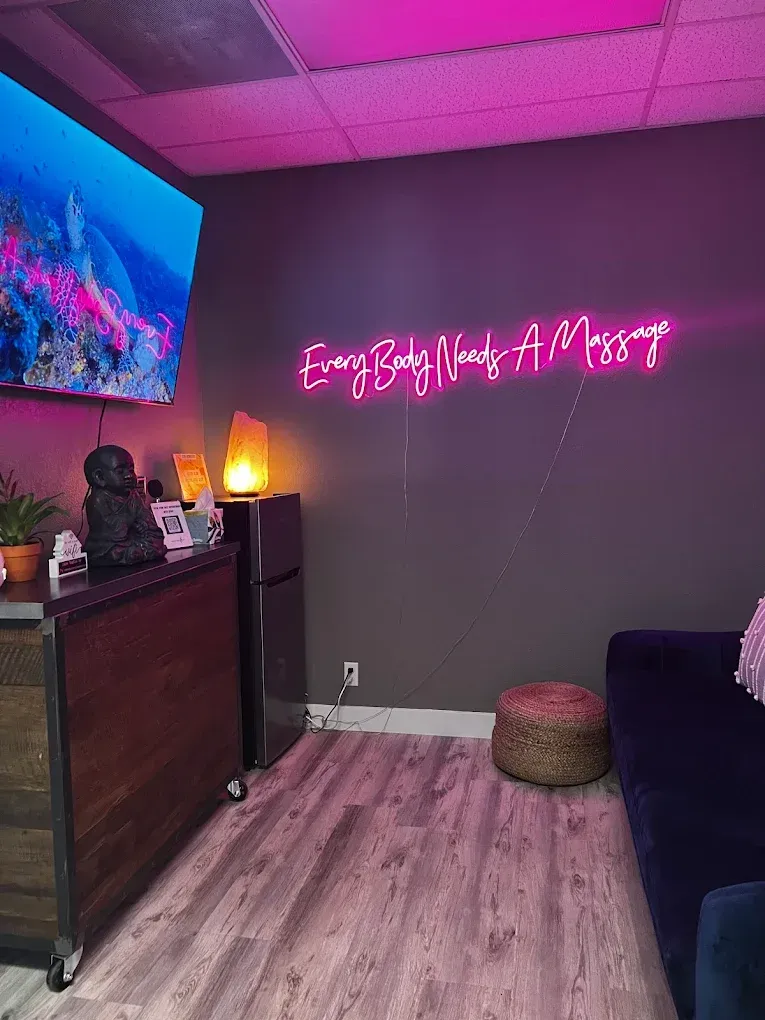 Massage room with neon sign: