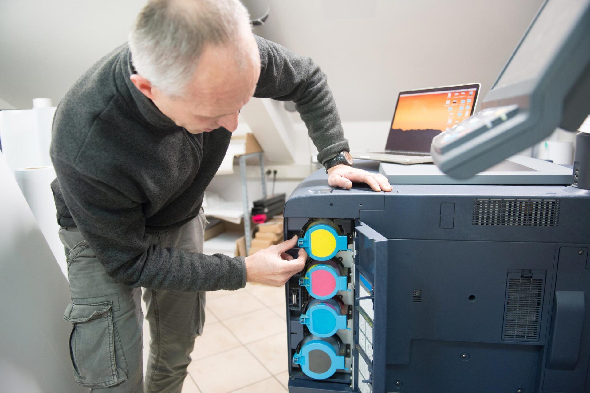 Man Changing Printer Cartridge — Fort Wayne, IN — Copy Solutions