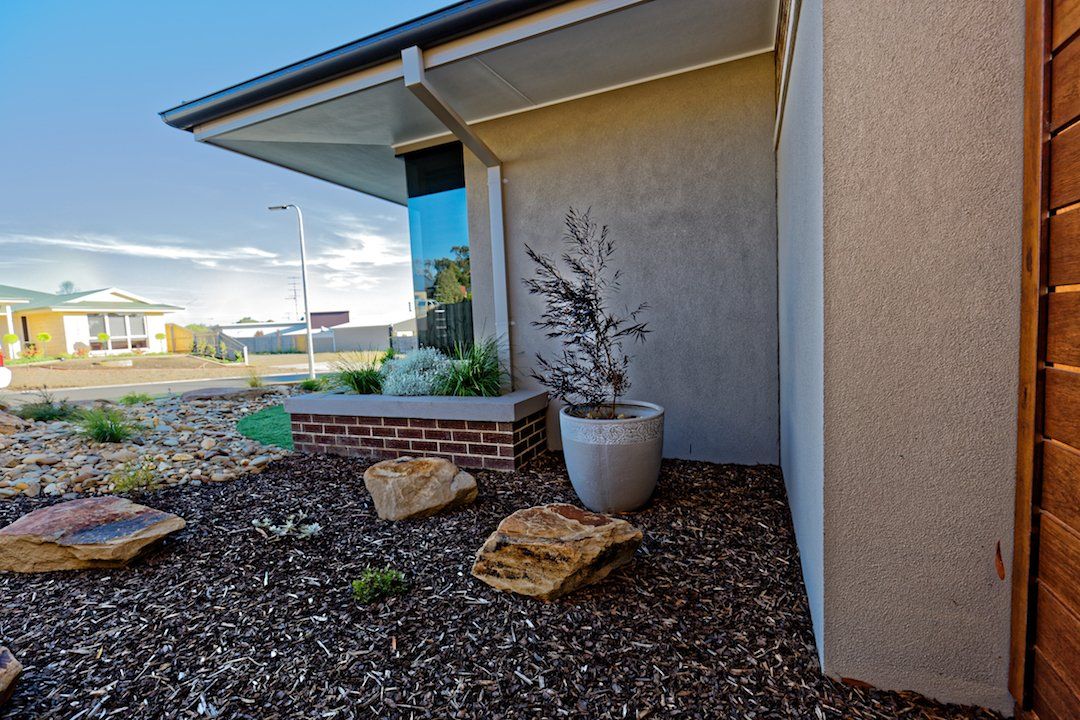 A house with a potted plant in front of it.