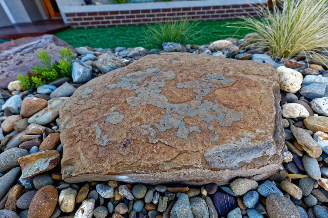 A large rock is sitting on top of a pile of rocks.