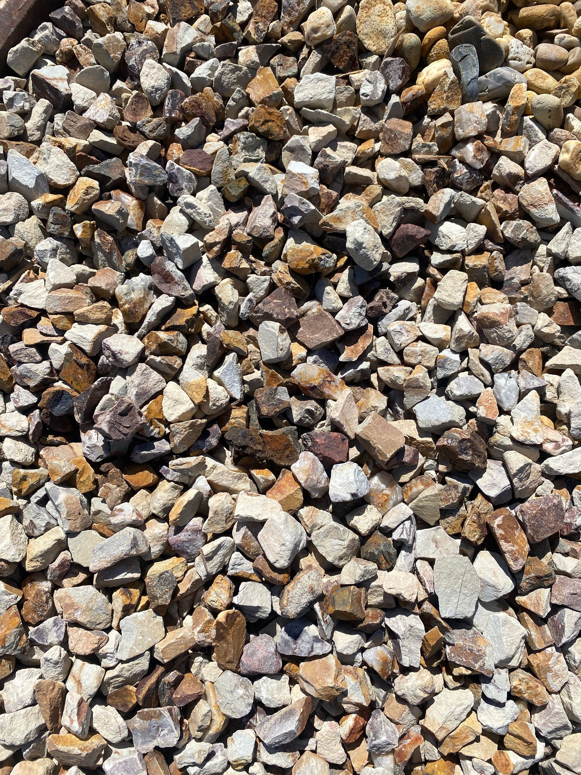 A pile of gravel is sitting on the ground.