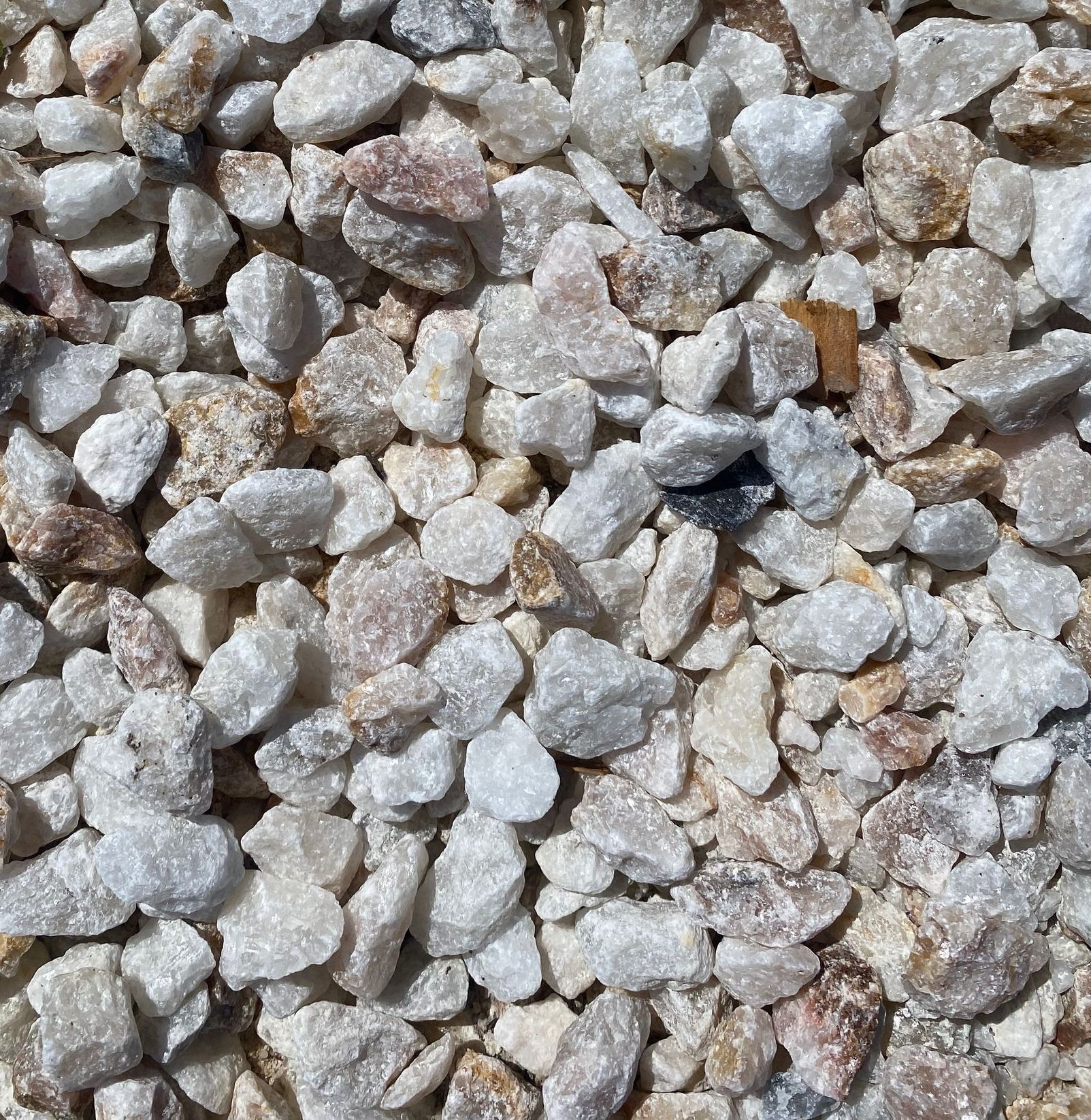 A pile of white gravel is sitting on the ground.