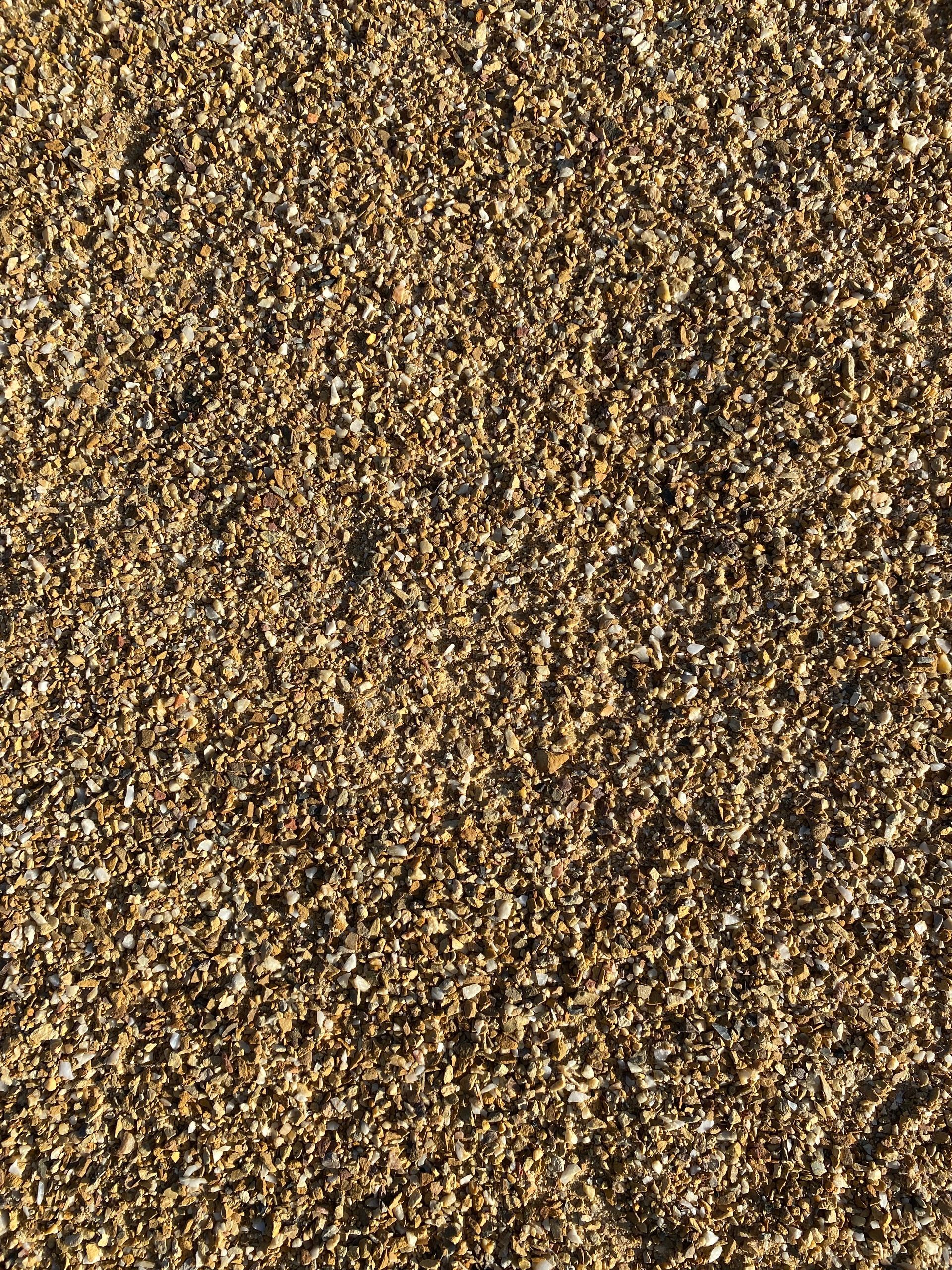 A close up of a pile of brown gravel.