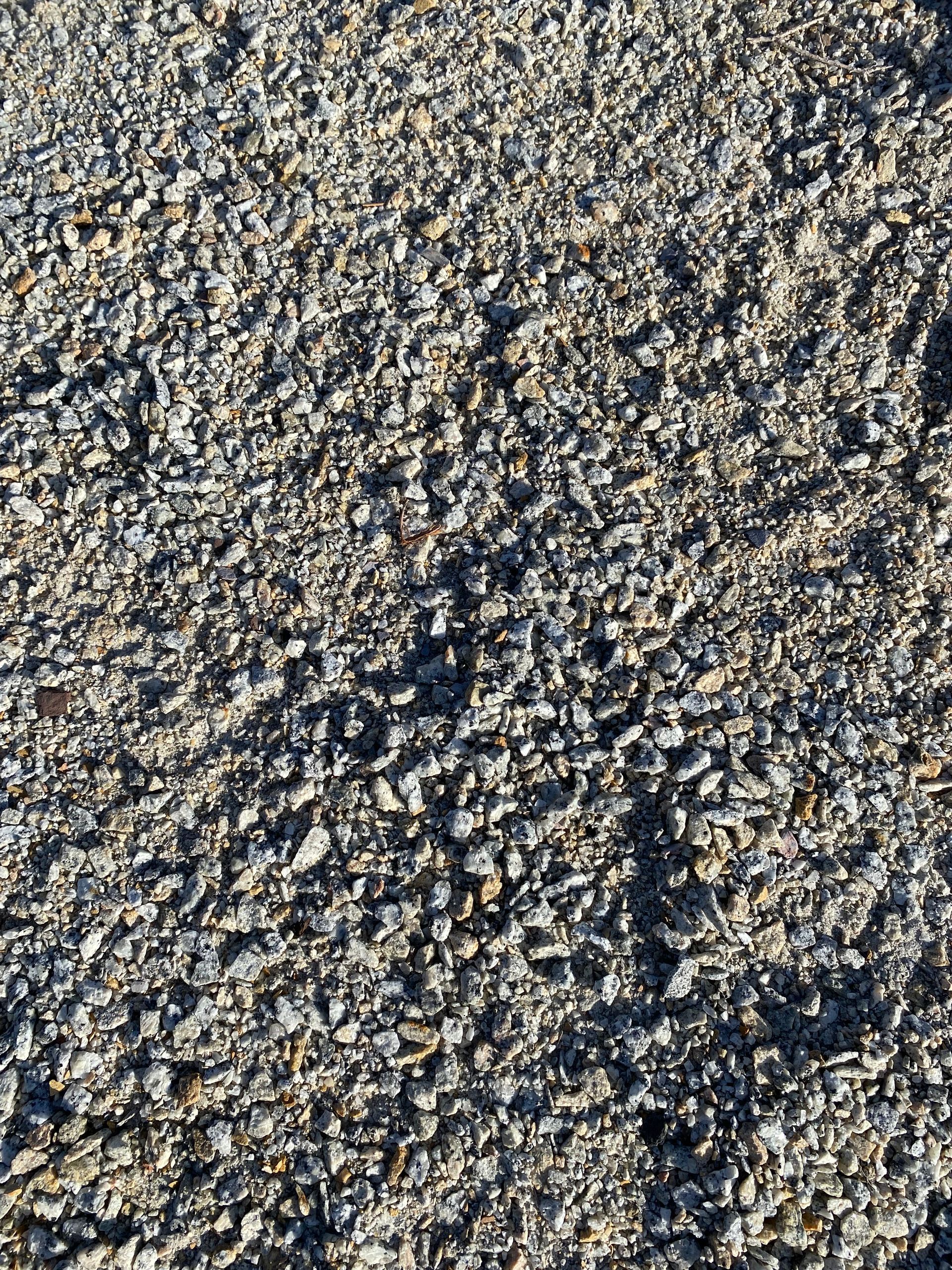 A pile of gravel is sitting on the ground.