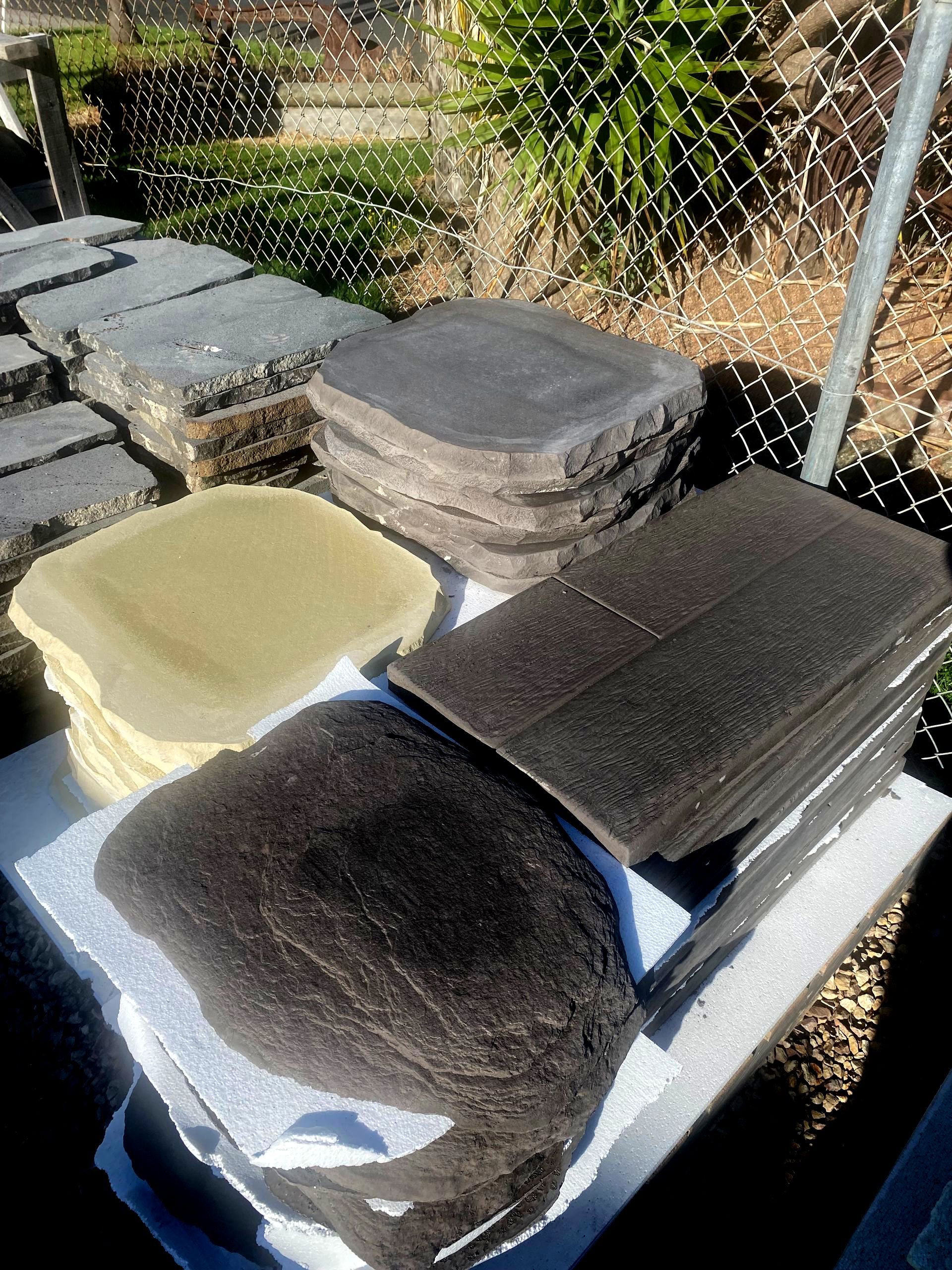 A stack of foam cushions sitting on top of a table next to a chain link fence.