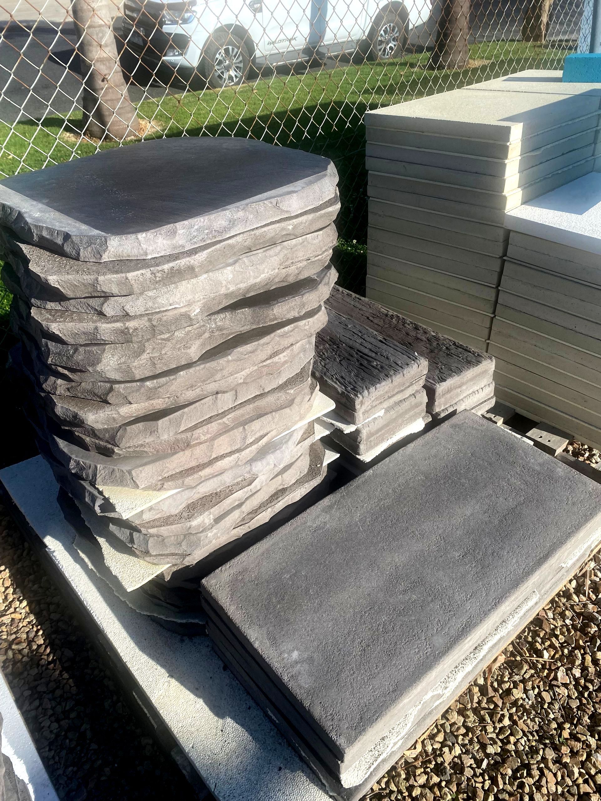 A pile of concrete slabs stacked on top of each other on a table.