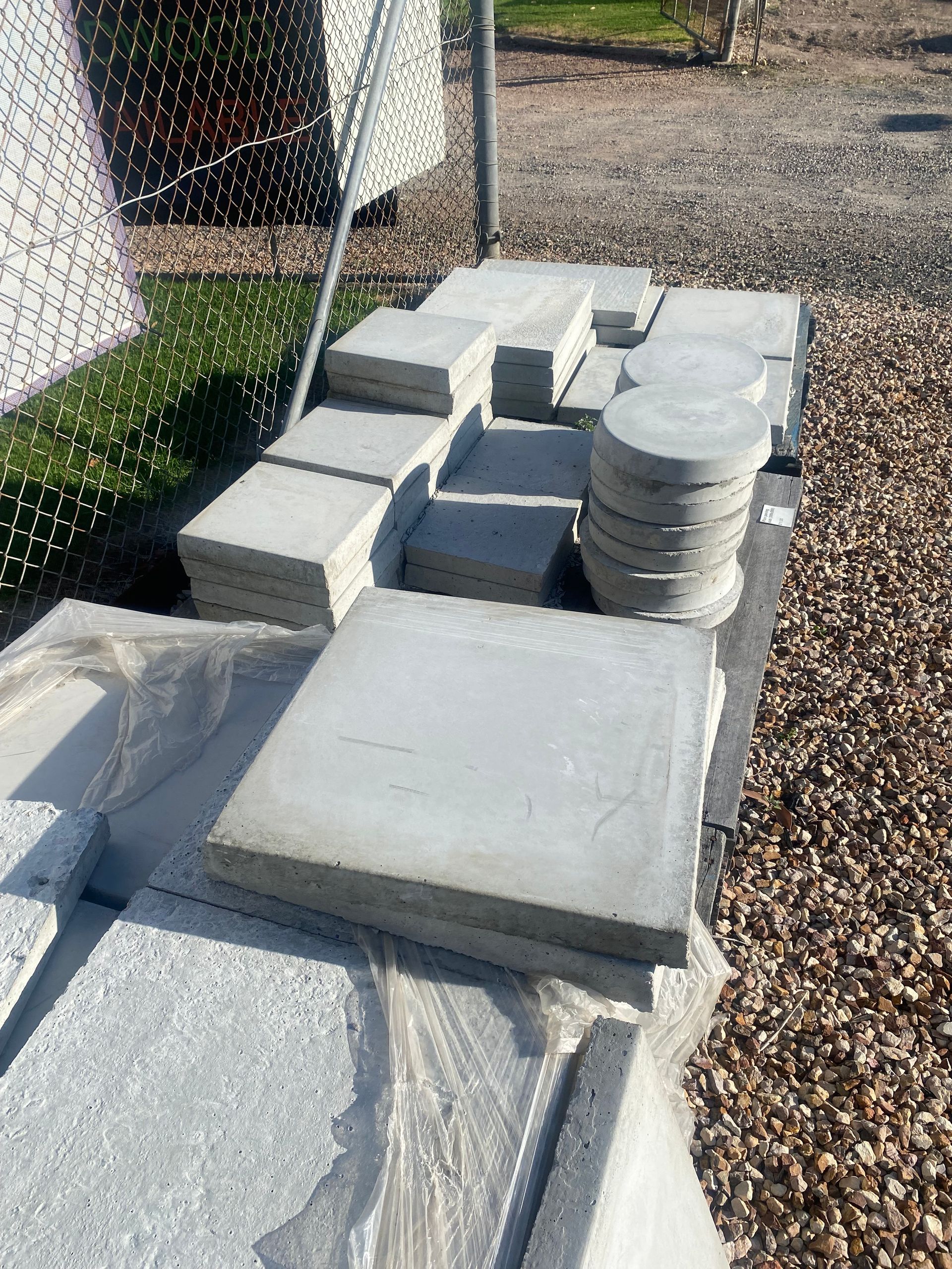 A pile of concrete tiles sitting on top of a pile of gravel.