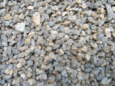 A pile of gravel is sitting on the ground.