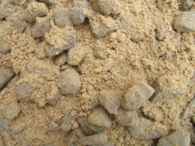 A close up of a pile of sand and rocks.