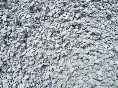 A pile of gravel is sitting on the ground.
