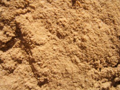 A pile of sand is sitting on the ground.