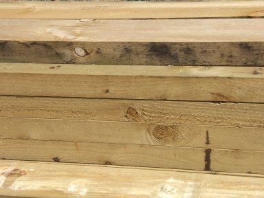 A close up of a pile of wood stacked on top of each other.