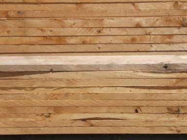 A stack of wooden boards sitting on top of each other on a table.