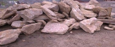 A pile of rocks is sitting on the ground.