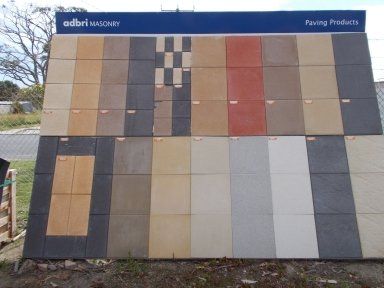 A display of tiles with a sign that says paving products