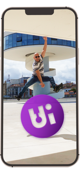 A man is jumping in the air next to a purple ball with the word ui on it.