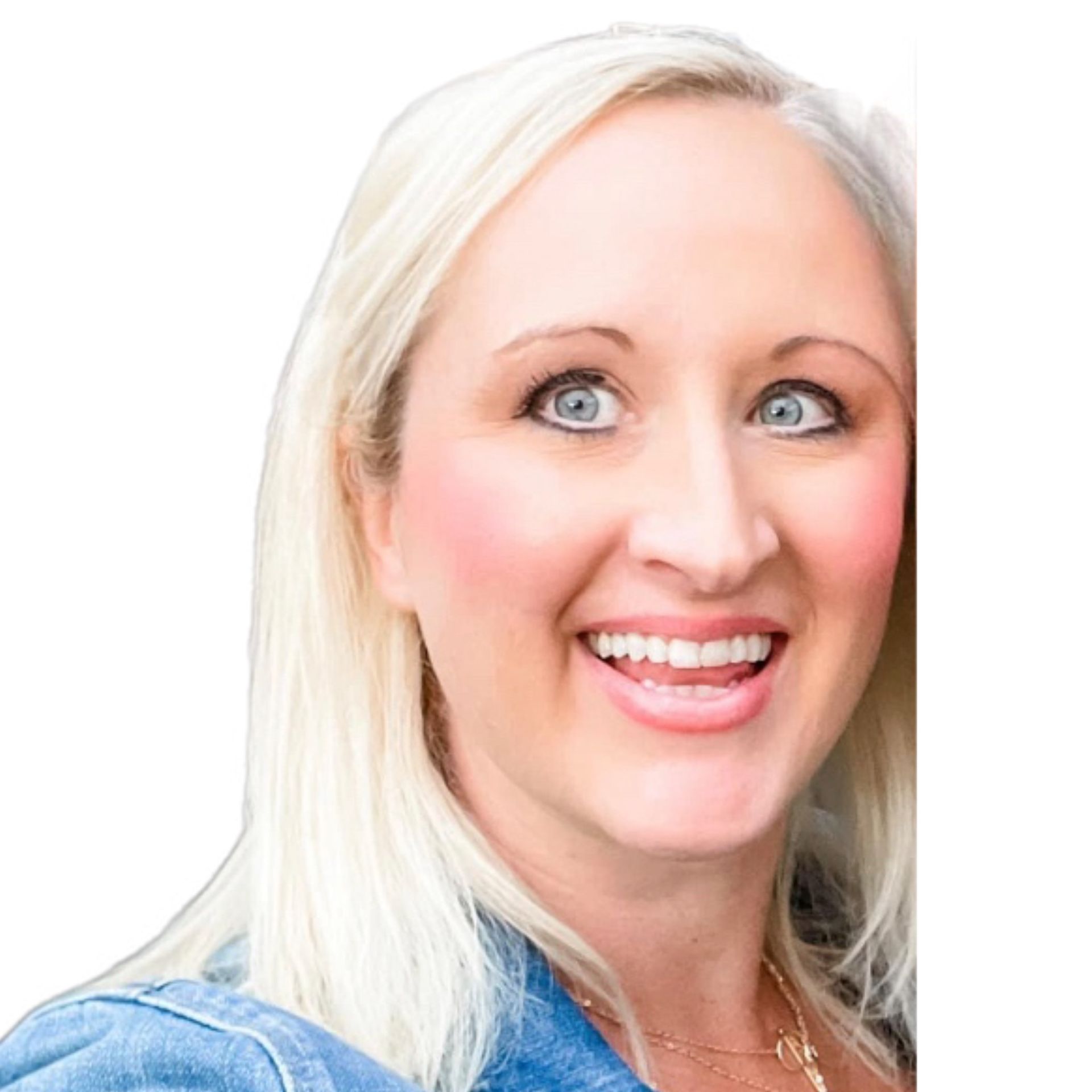 A woman in a green sweater is smiling in front of a window