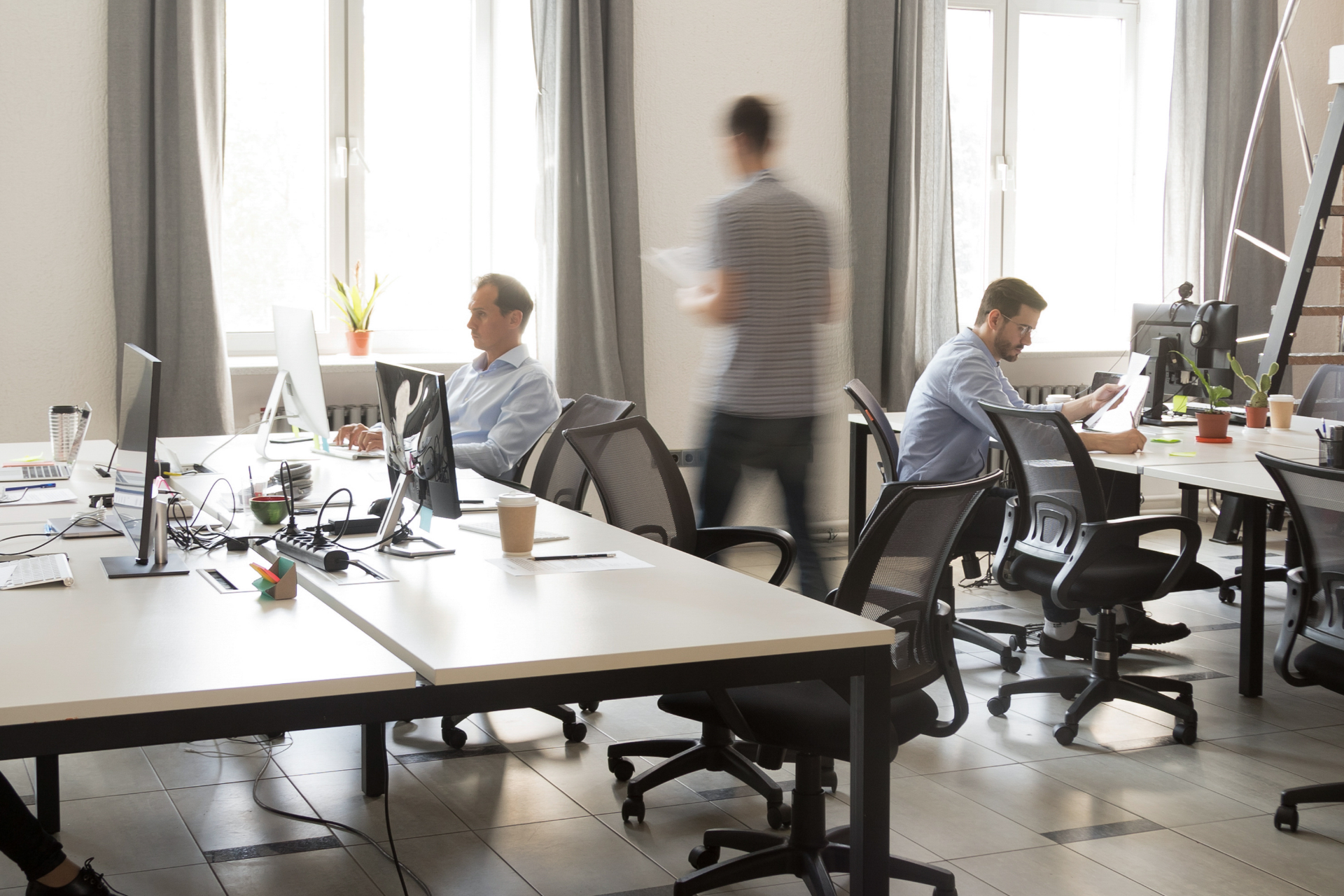 men working in a shared office space