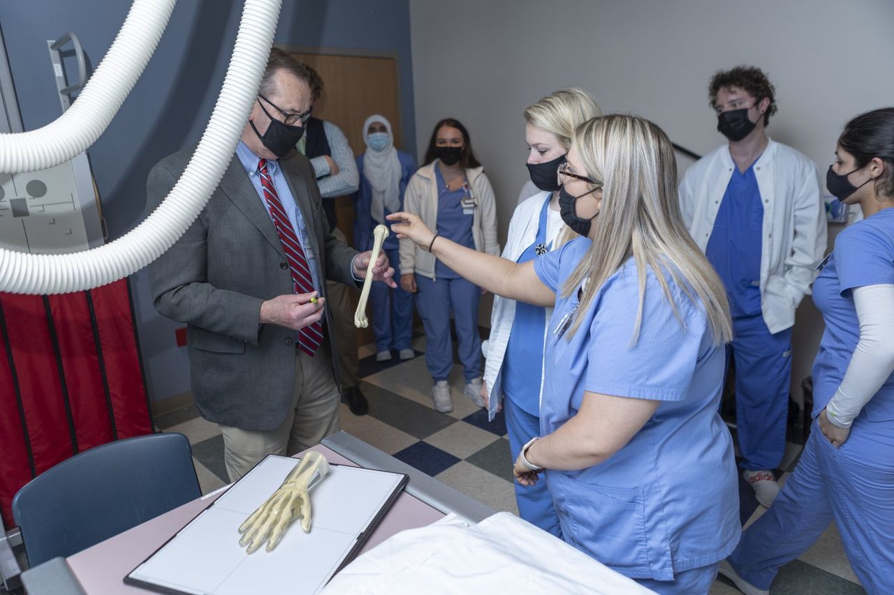 Professor Holding Bone — Nashville, TN — NGH School of Health Sciences