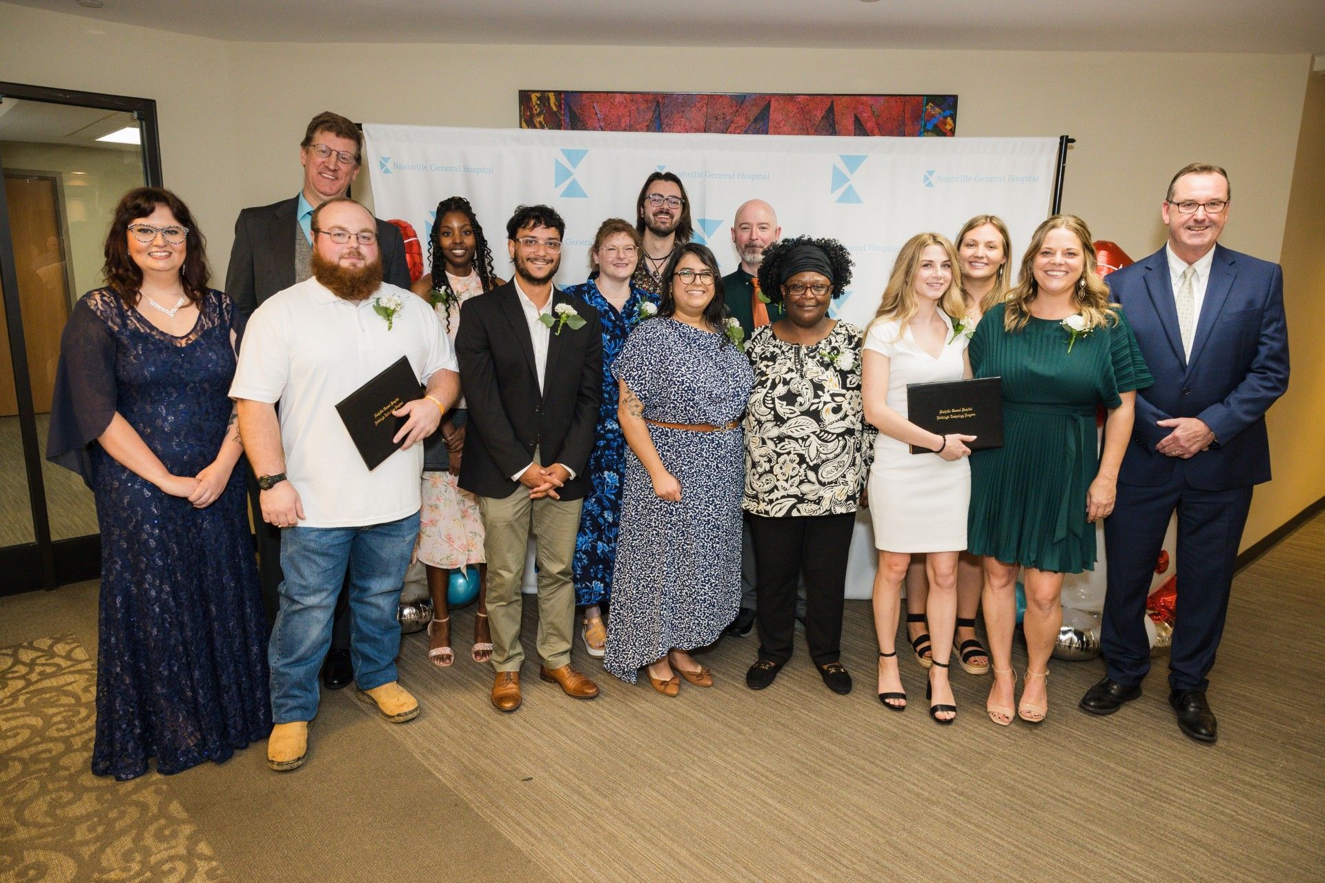 A group of people are posing for a picture in a room.