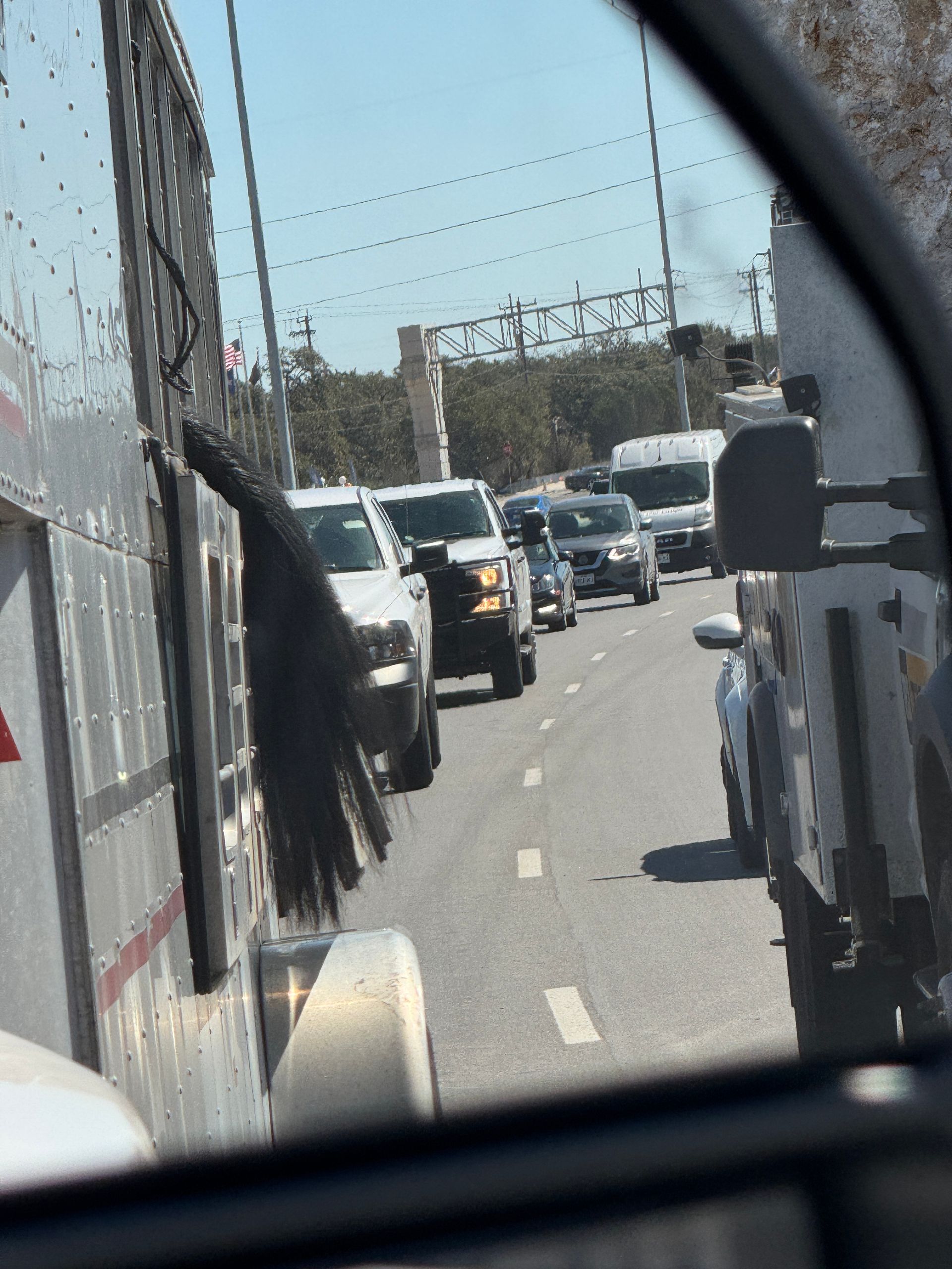 A row of cars are lined up on the side of the road
