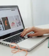 Laptop displaying a marketing concept screen with icons, charts, and words like branding, success, product, and strategy