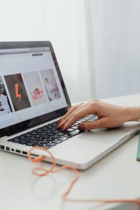 Laptop displaying a marketing concept screen with icons, charts, and words like branding, success, product, and strategy