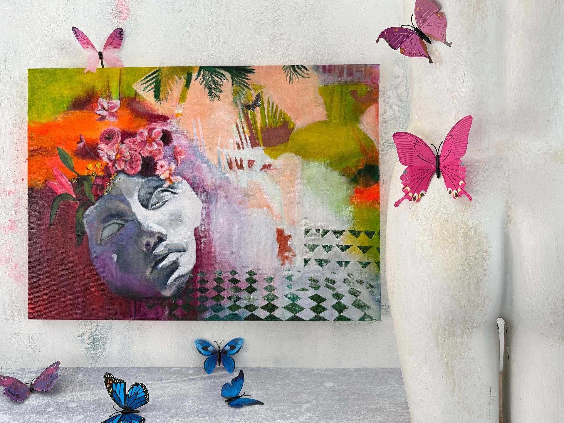 A painting of a woman 's face with butterflies around it