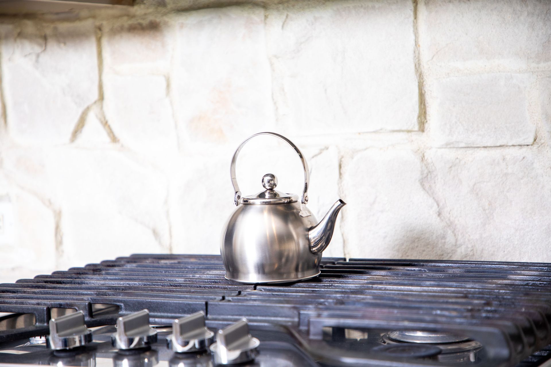Rustic cabin living room with wood beams, dark wood floors, and cozy furniture.