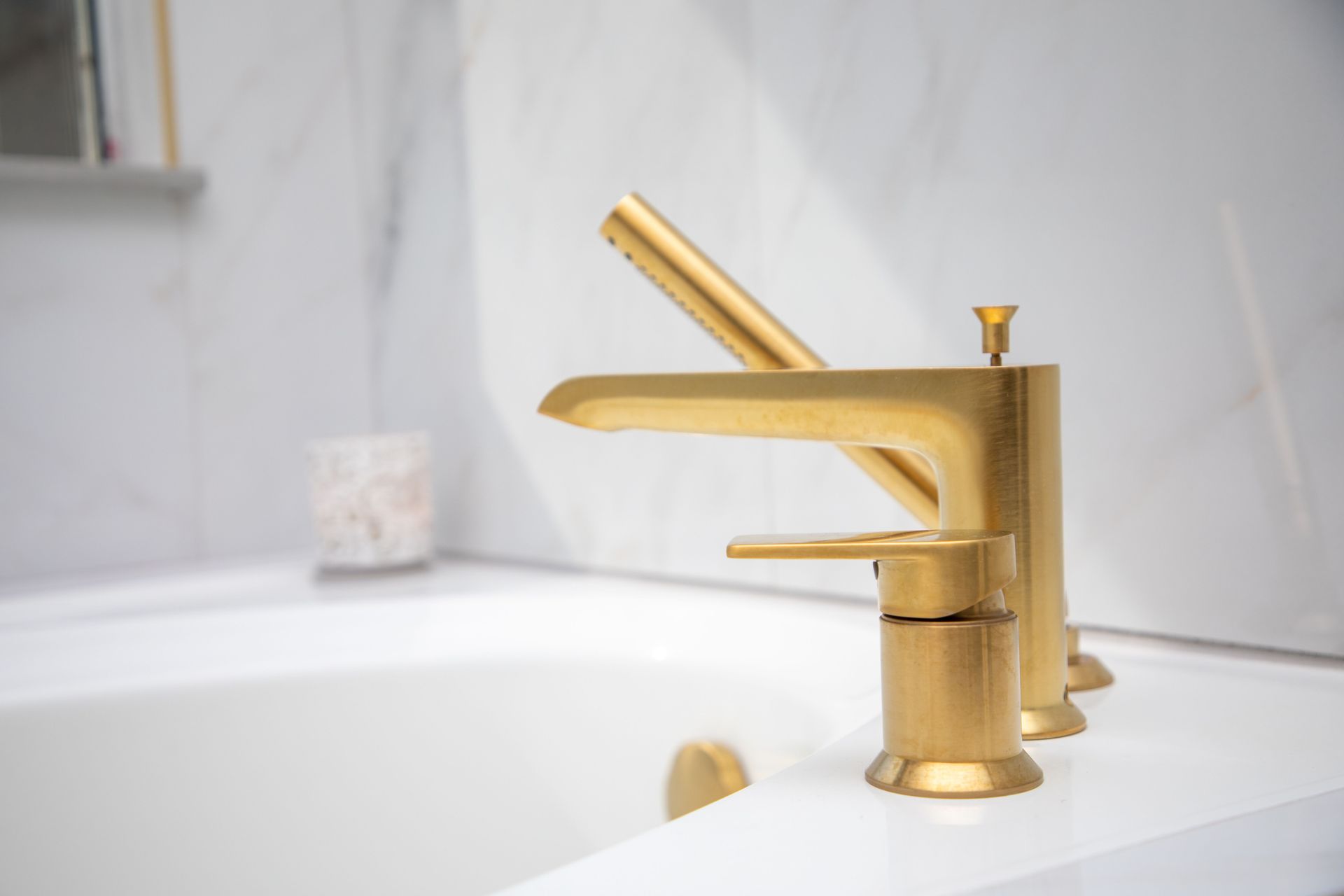 Bedroom with a wooden bed, white bedding, and a window overlooking a backyard. White walls, carpet, and furniture.