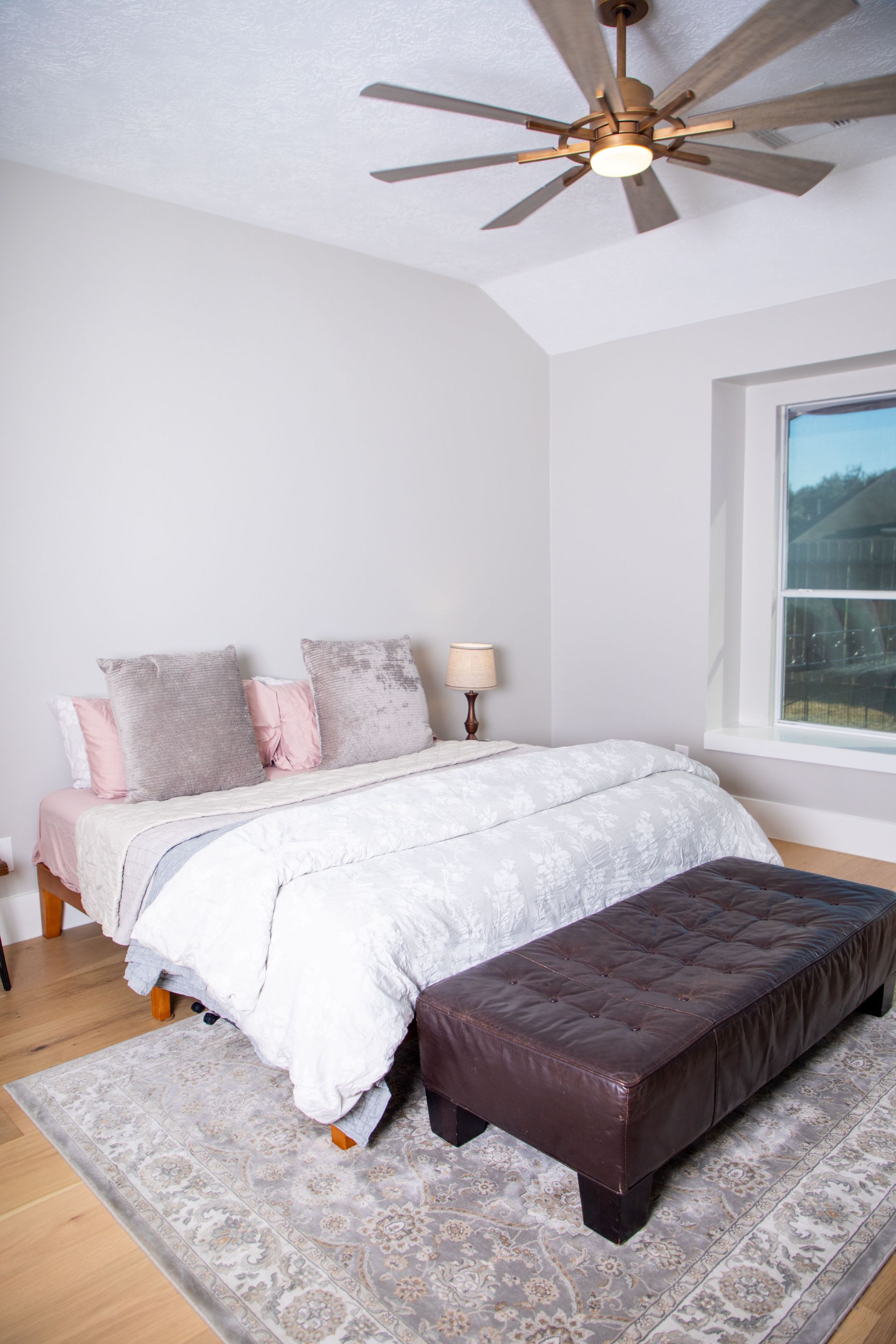 Outdoor patio with fire pit, orange sofas, and a building with arched doorway at dusk.
