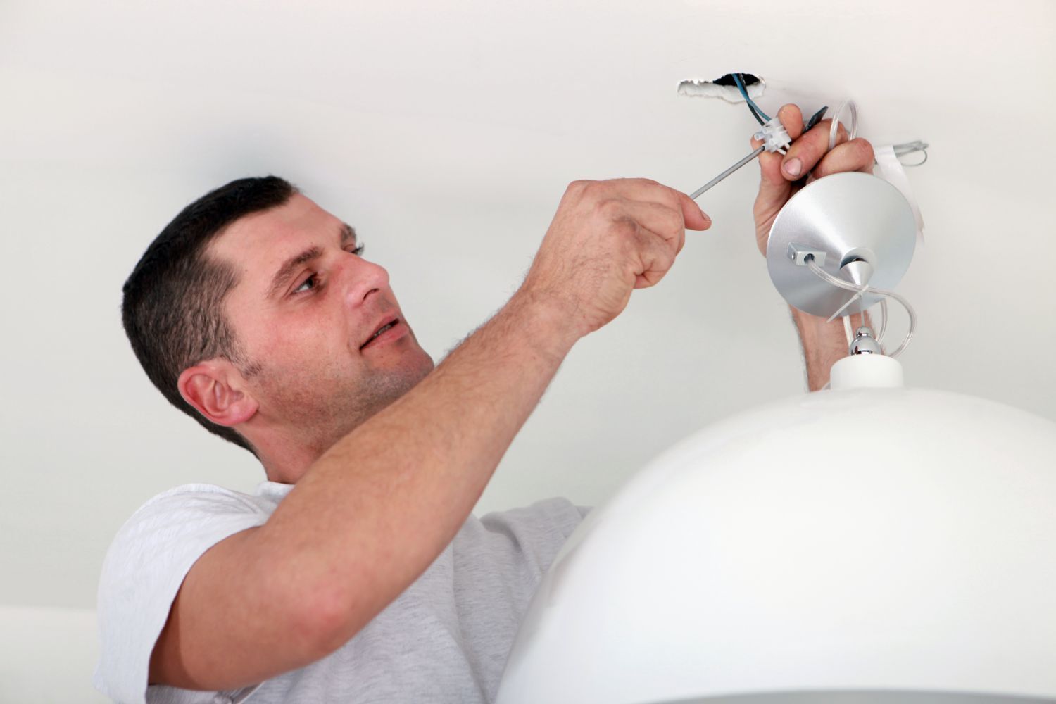 Electrician fixing light wires