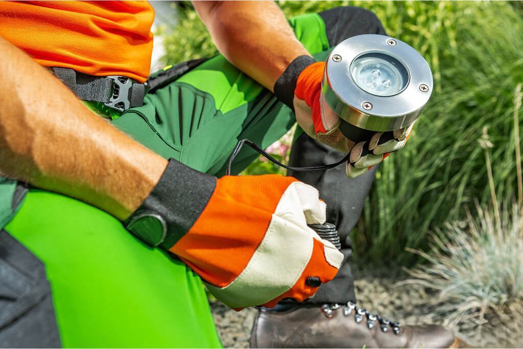 Technician preparing ground lighting fixture