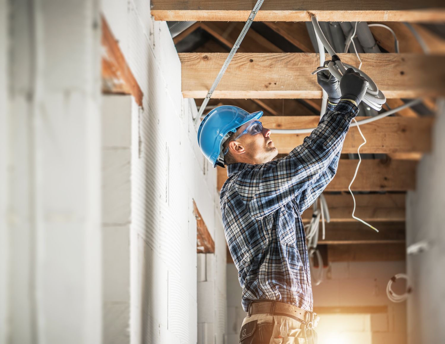 Electrician wiring residential ceiling