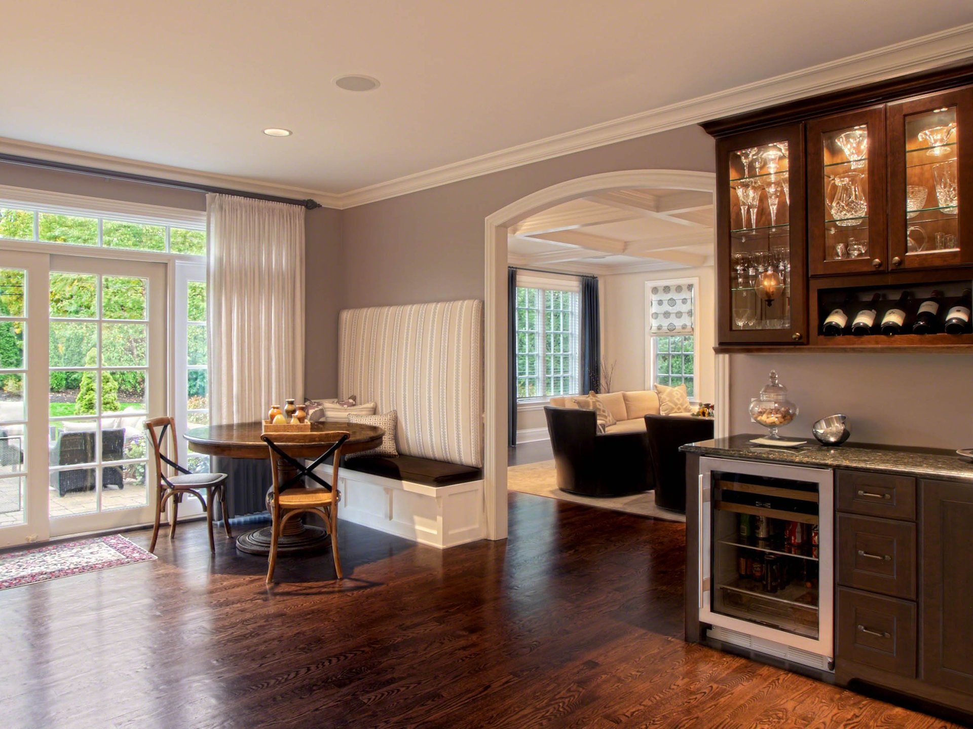 A kitchen with a table , chairs , and a refrigerator.