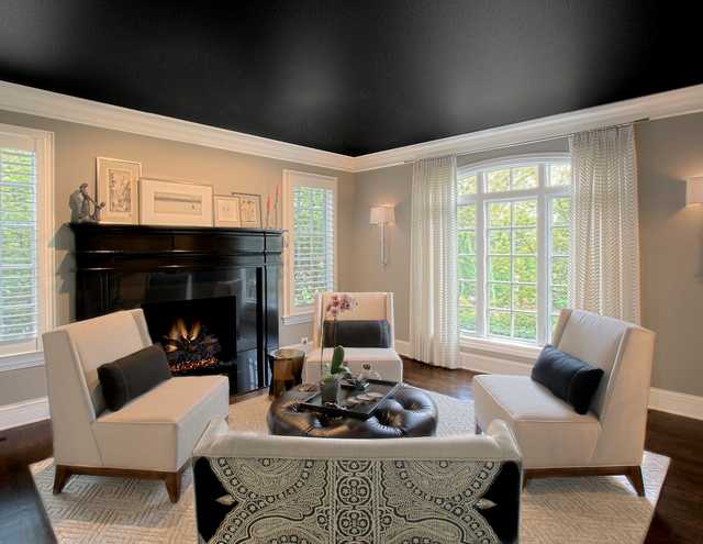 A living room with a black ceiling and a fireplace.